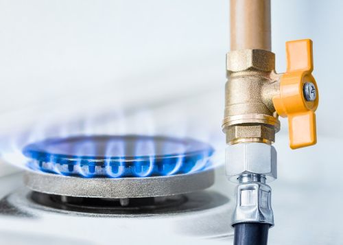 Image of a gas pipe with open yellow valve and burning gas burner. Visual concept for legal blog on a deadly gas explosion