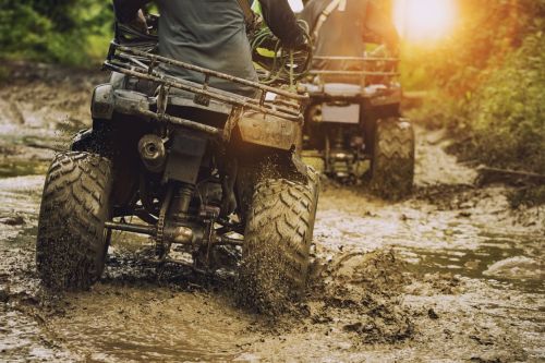 All-terrain vehicle (ATV) in the mud. Visual concept for a personal injury blog discussing the need for an attorney in a all-terrain vehicle accident.