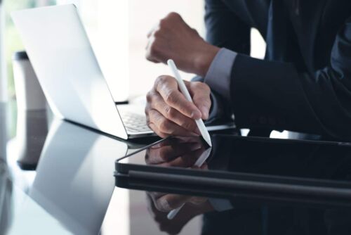 Lawyer using stylus pen on digital tablet with laptop computer on table at office.Visual concept for what to expect as t personal injury deposition.