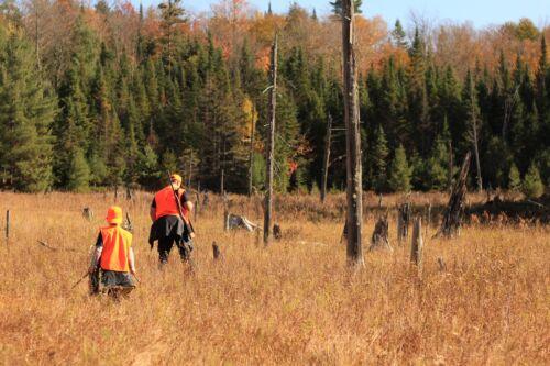 Father and son in hunting gear. Visual concept for a blog discussing hunting injuries and product liability.